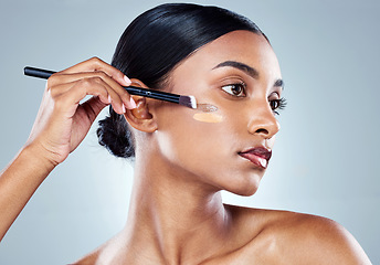 Image showing Makeup brush, foundation and woman with cosmetics, natural beauty and skincare. Cosmetic, young female model and self care with contour and face product with highlighter for skin glow in studio