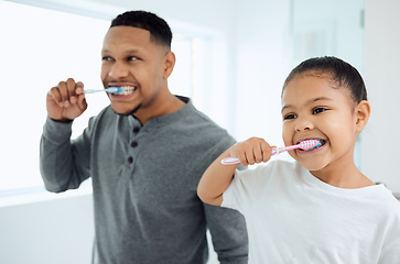 Image showing Family, girl and father brushing teeth, home and oral hygiene with happiness, learning and development. Love, dad or daughter in a bathroom, dental care or female child with fresh breath and wellness