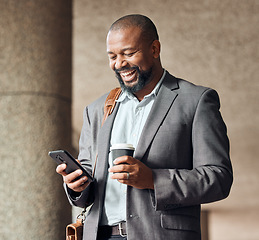 Image showing Phone, coffee and businessman in the city walking to corporate office while networking. Happy, town and African male employee browsing on social media, mobile app or internet while commuting to work.