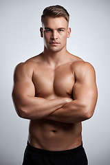 Image showing Portrait, man and bodybuilder with arms crossed on studio background, backdrop and topless abs. Sexy, serious and strong male model, sports athlete and fitness for exercise, confidence and muscles