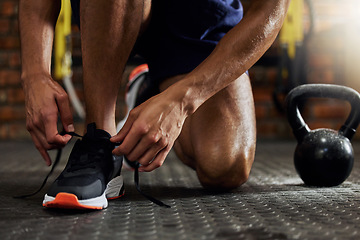 Image showing Tie shoes, man hands and gym for fitness, strength training and exercise. Athlete feet, sport routine and male person prepare to start workout and wellness class at a health center with sneakers