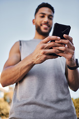 Image showing Fitness, sports and man with phone in hands, checking health app, social media or workout tracker online. Smile, wellness and male athlete with cellphone to check digital exercise schedule in park.