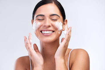 Image showing Skincare, foam wash and woman in a studio for natural, cosmetic and beauty hygiene routine. Wellness, health and female model cleaning her face with a facial cleanser isolated by a white background.