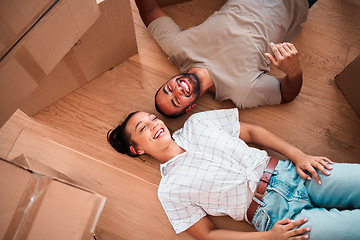 Image showing Top view, happy couple and moving into new home on floor, ground and relax from packing boxes. Man, woman and taking a break in house from property mortgage, real estate and investment of apartment