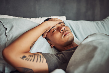 Image showing Tired, rest and sick man sleeping in the bedroom while in recovery or healing in his apartment. Burnout, illness and male person with a headache or fever taking a nap in bed at his modern home.