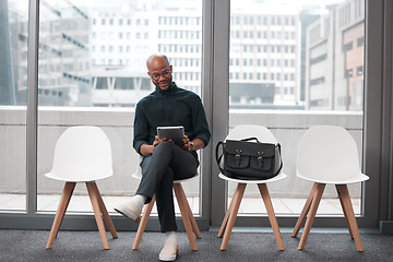 Image showing Business man, tablet and chair in waiting room, queue and opportunity of job interview, recruitment process or human resources. Black male, digital technology and browsing internet in line for hiring