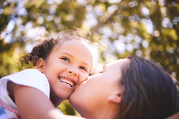 Image showing Mother, child and kiss in nature, smile or bonding on summer holiday vacation. Mom, kissing cheek and happy girl, love and affection, care and enjoying quality family time together outdoor in park.