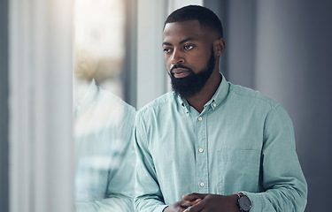 Image showing Idea, window and a business black man thinking or planning in his professional office at work. Flare, problem solving and decision with a serious young male employee standing alone in the workplace