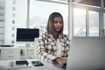 Image showing Business woman, laptop and writer typing in office workplace. Copywriting, computer and female Indian person reading, work or writing email, focus on report or proposal, research or planning project