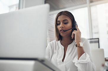 Image showing Laptop, headset and a woman in call center for customer service, telemarketing or help desk. Female person, consultant or agent with technology for contact us, telecom support or crm at a company