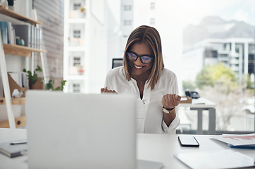 Image showing Business woman, success and laptop to celebrate profit, win or achievement in a modern office. African female entrepreneur at a desk with motivation and technology for bonus, victory and promotion