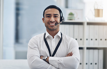 Image showing Smile, headset and a man in a call center for customer service, telemarketing or help desk. Asian male person with arms crossed for contact us, telecom support or crm consultant or agent at a company