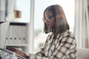 Image showing Laptop, editor and business woman typing in office workplace. Writer, computer and female Indian person reading, working or writing email, report or proposal, research online or planning project.