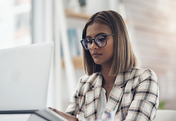 Image showing Copywriting, laptop and business woman typing in office workplace. Writer, computer and female Indian person reading, working or writing email, report or proposal, research online or planning project