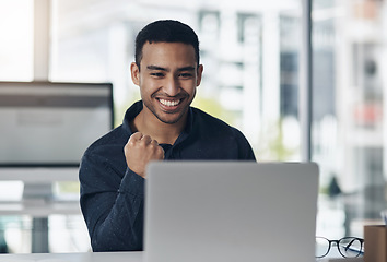 Image showing Young business man, celebrate and laptop with smile, winning or success on stock market in office. Indian businessman, computer and winner with fist celebration, profit and bonus in online gambling