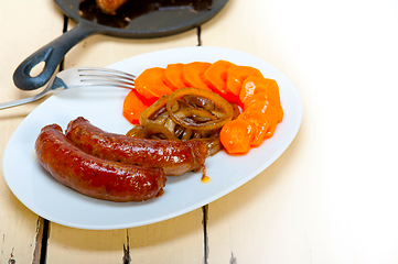 Image showing beef sausages cooked on iron skillet