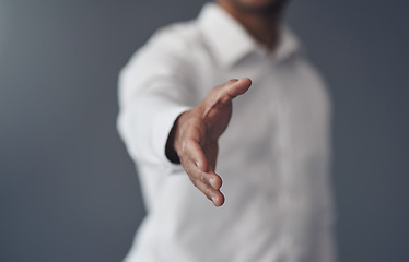 Image showing Handshake, success and offer of business man isolated on a studio background for agreement, introduction or welcome. Corporate person shaking hands in pov meeting, deal or congratulations and thanks