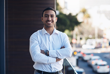 Image showing Portrait, business and man with arms crossed, smile and confident guy with happiness, startup success and office balcony. Face, male person and employee with a career, entrepreneur and professional