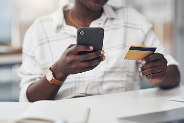 Image showing Business woman, phone and credit card in hands for online shopping, e commerce and banking. African person at a desk with a mobile phone for fintech website, bill payment or money transfer in office