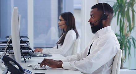 Image showing Black man, call center and computer with typing in office for email communication, tech support or telemarketing. Crm, consulting and african agent with woman, pc and customer service in workplace