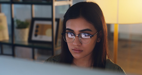 Image showing Computer, night and face with a woman editor working in her office for a journalism or news report. Focus, editing and reporting with a young journalist at work on a desktop for online content