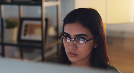 Image showing Computer, night and face with a woman journalist working in her office for editing a news report. Focus, editing and reporting with a young female editor at work on a desktop for online content