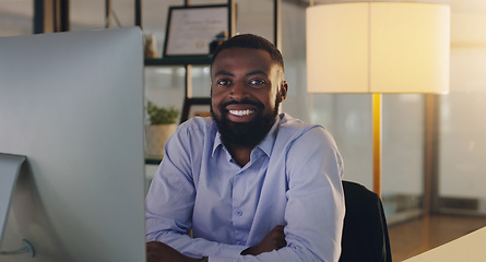 Image showing Black man, business and portrait in night, office and smile with computer, pride and arms crossed. African businessman, auditor or entrepreneur in overtime with pc, finance or happy in dark workplace