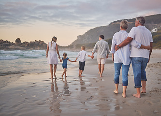 Image showing Family, generations and back with walking, beach and sunset with men, women and children with love. Parents, grandparents and kids by ocean, holding hands and bond on summer vacation with solidarity