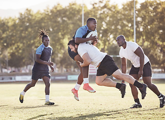 Image showing Sports action, rugby and men on field for match, practice and game in tournament or competition. Fitness, teamwork and players tackle for exercise, training and performance for winning ball to score