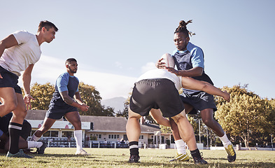 Image showing Sports, rugby and men tackle on field for match, practice and game in tournament or competition. Fitness, teamwork and players playing on grass for exercise, training and performance to win ball