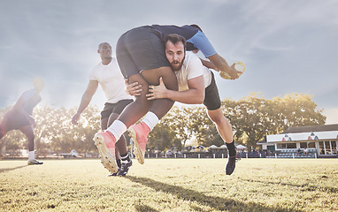 Image showing Sports, rugby and men tackle for ball on field for match, practice and game in tournament or competition. Fitness, teamwork and sport players playing for exercise, training and performance to win