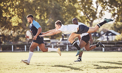 Image showing Sports, rugby and men in action on field for match, practice and game in tournament or competition. Fitness, teamwork and strong players tackle for exercise, training and performance to win ball