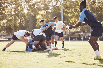 Image showing Sports, rugby and men pass ball on field for match, practice and game in tournament or competition. Fitness, teamwork and group of players playing for exercise, training and performance for winning