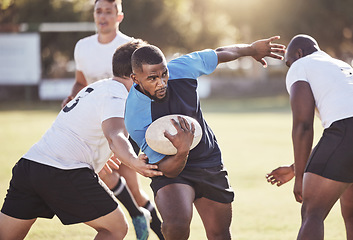 Image showing Sports, rugby and men running on field for match, practice and game in tournament or competition. Fitness, teamwork and group of players tackle for exercise, training and performance to win ball