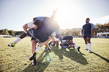 Image showing Sports, rugby and men tackle on grass for match, practice and game in tournament or competition. Fitness, teamwork and players playing for exercise, training and performance to win ball on field