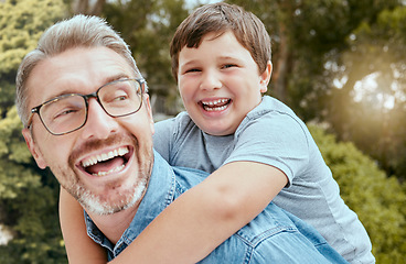 Image showing Piggyback, family fun and father with child in a park happy, playing and laughing in nature. Hug, love and parent carrying son in a garden, laugh and enjoying games, smile and together on the weekend