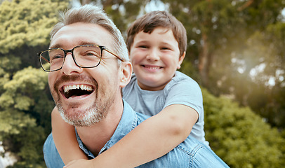 Image showing Family fun, piggyback and father with child in a park happy, playing and laughing in nature. Hug, love and parent carrying son in a garden, laugh and enjoying games, smile and together on the weekend