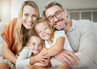 Image showing Parents, portrait and sofa with hug, kids and smile with love, bonding and care in family home together. Father, mother and daughters with happiness, embrace and relax on lounge couch in house