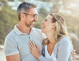 Image showing Happy, smile and love with couple at beach for laughing, travel and summer vacation. Happiness, holiday and romance with man and woman hugging on seaside date for bonding, affectionate and care