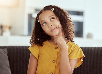 Image showing Thinking, young girl and home with ideas and inspiration on a living room sofa. Cute, decision and child with an idea and option consideration on a lounge couch in a house with youth and weekend plan