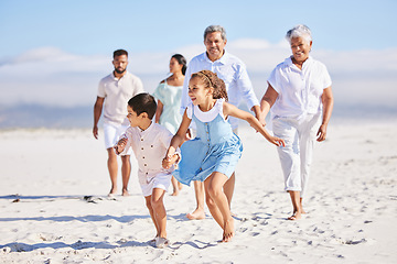 Image showing Holiday, happy and big family running on the beach for playing and bonding on a weekend trip. Travel, excited and children having fun with their grandparents and parents by the ocean on a vacation.