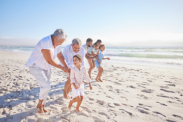 Image showing Vacation, travel and big family running on the beach for playing, bonding and spending quality time. Happy, excited and children having fun with their grandparents and parents by the ocean on holiday