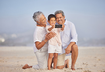 Image showing Selfie, travel and grandparents with child at beach for vacation, bonding and generations. Picture, happy and young boy with senior man and woman in nature for smile, happiness and technology