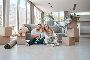 Image showing Moving, box and portrait of family in new house for property, investment or future. Real estate, happy and renting with parents and children in living room of home for relocation, homeowner and relax