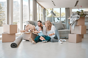 Image showing Moving, box and teddy bear with family in new house for property, investment or future. Real estate, happy and renting with parents and baby in living room of home for relocation, homeowner and relax