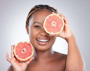 Image showing Beauty, grapefruit and skincare with portrait of black woman in studio for natural, cosmetics or vitamin c. Nutrition, diet and detox with model on grey background for citrus fruit and health product