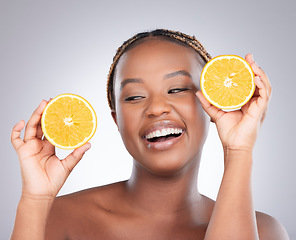 Image showing Beauty, orange and skincare with black woman in studio for natural, cosmetics and vitamin c. Nutrition, diet and detox with face of female model on grey background for citrus fruit and health product