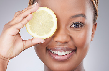 Image showing Portrait, lemon and skincare with black woman in studio for natural, cosmetics or vitamin c. Nutrition, diet and detox with face of female model on grey background for citrus fruit and health product