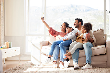 Image showing Parents, children and sofa selfie with smile, happiness and bond in lounge for social media app. Father, mother and daughters with care, love and together for profile picture, blog and happy on couch