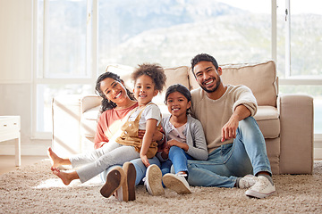 Image showing Happy, love and portrait of a family in the living room sitting on the carpet in their house. Happiness, smile and children relaxing on the floor with their parents in the lounge of a modern home.